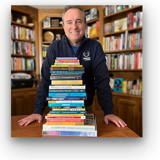 Noah St. John behind his highly stacked life-changing books